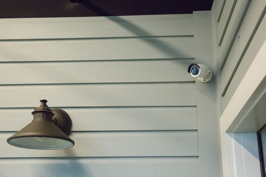 A bullet camera mounted on the exterior of a home.